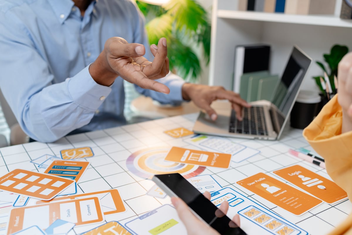 Designer presenting website layouts during a client workshop